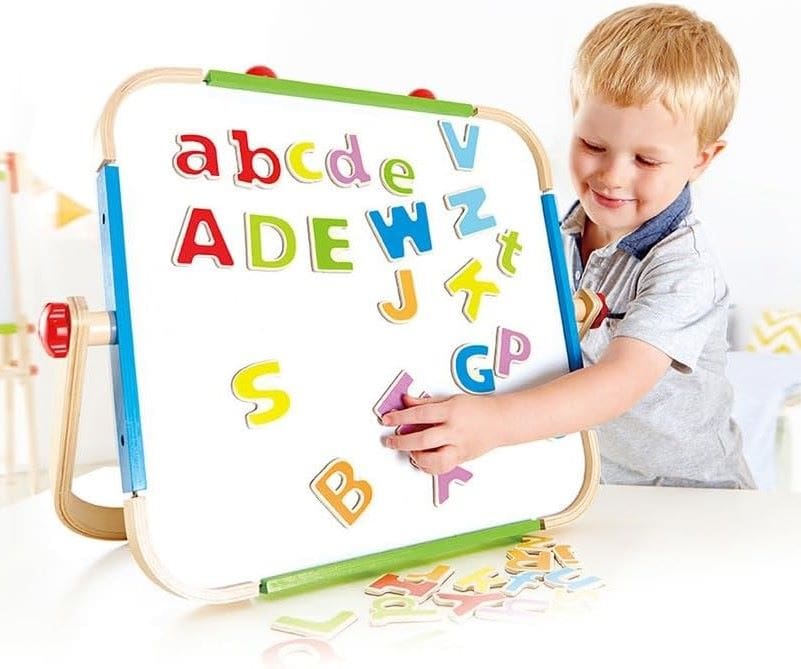 a boy placing an alphabet on the alphabet chart