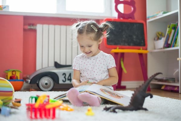 girl smiling and reading best interactive books