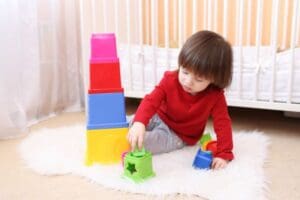 a kid is playing a toddler toys